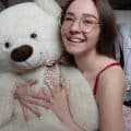 Teen girl Emmi-Hill rides her teddy bear